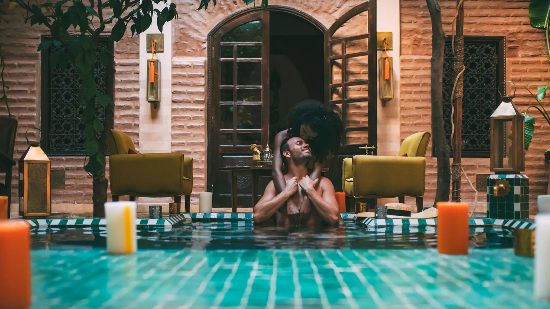Multiracial couple relaxing in a pool, enjoying their sex vacation